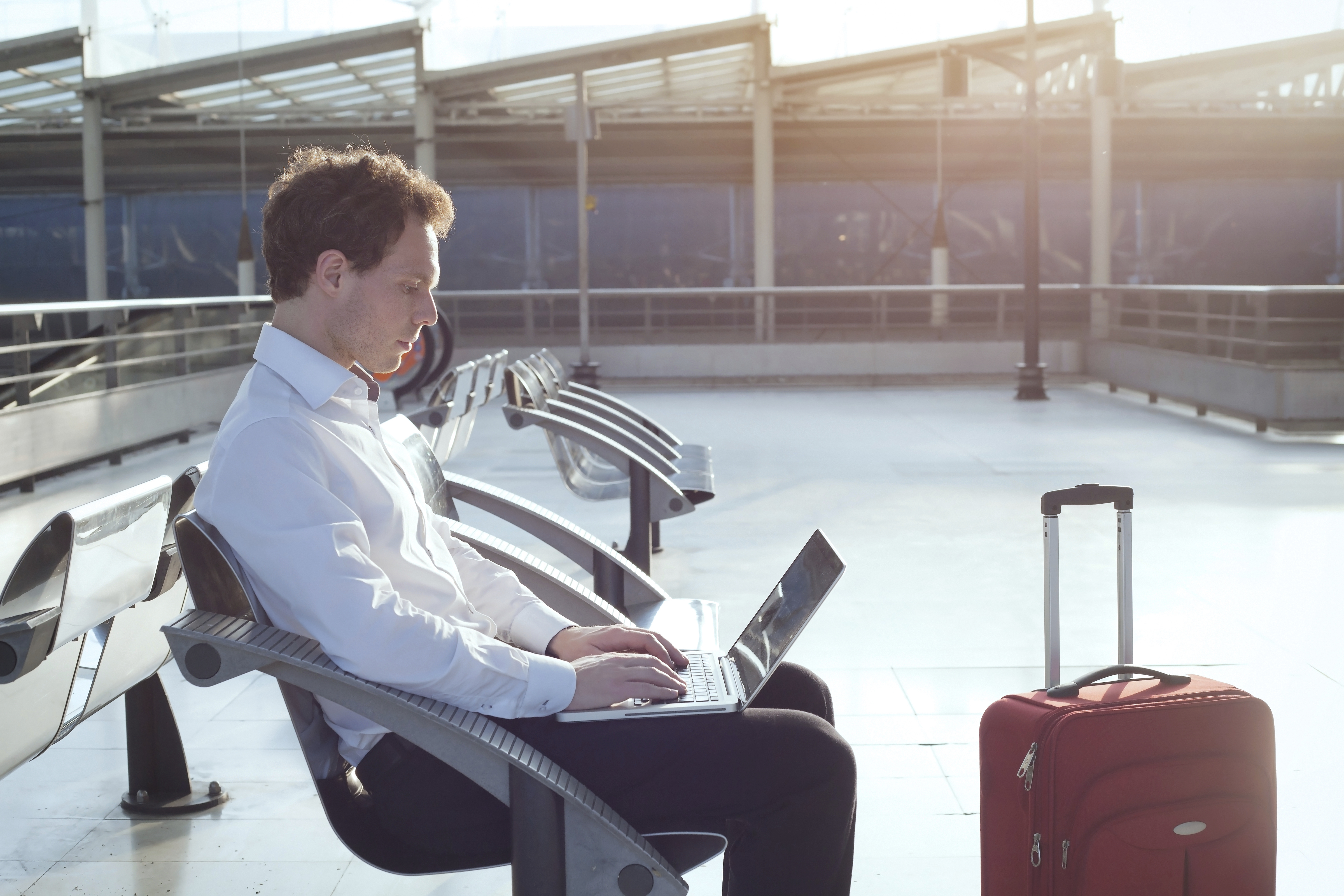 Man on laptop in the airport